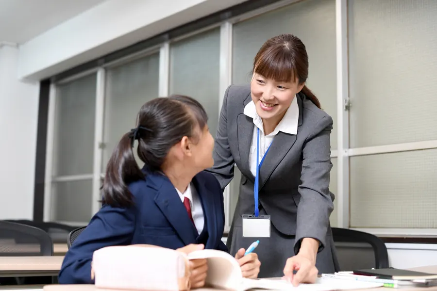 少人数の教室で、講師が生徒に声をかけながら進める授業の様子